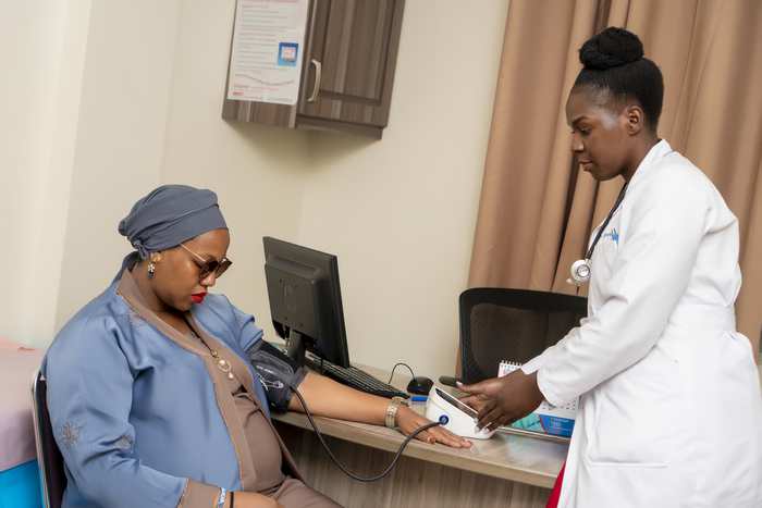 A doctor consulting with a patient in an examination room